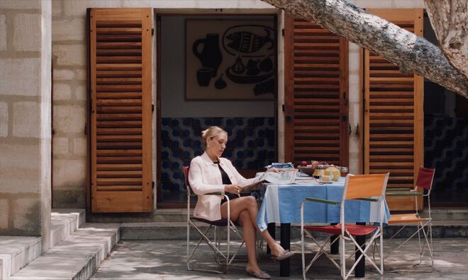 IMAGE: Still - Anne reads the paper